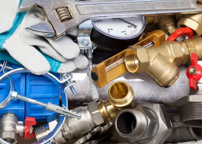 Plumbing tools and materials during professional plumbing services for drain cleaning in Hamilton, NJ.