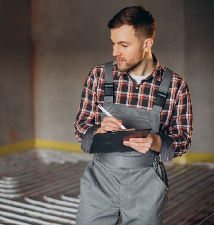 Plumber assessing plumbing systems with clipboard in Bordentown, NJ, highlighting expertise in commercial plumbing services.