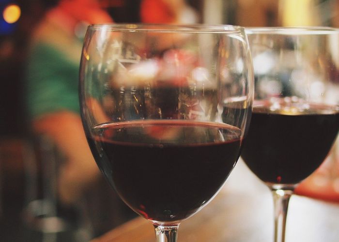Two glasses of red wine in a cozy setting, reflecting the ambiance of local wineries like Cream Ridge Winery and Terhune Orchards in Hamilton, NJ.