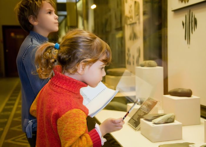 Children observing artifacts at the Roebling Museum, engaging with educational displays about bridge design and history.