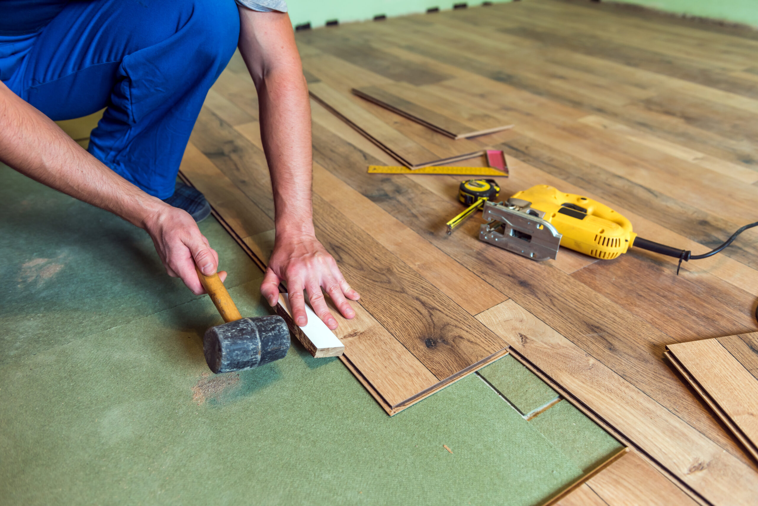 Alliance Service Professionals installing wood flooring